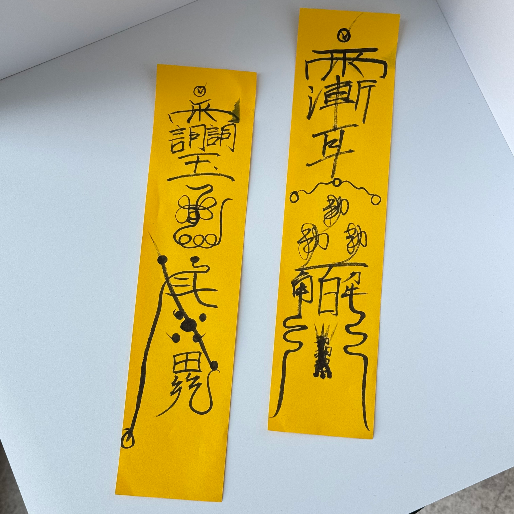Hand-drawn Taoist talismans on yellow ritual paper