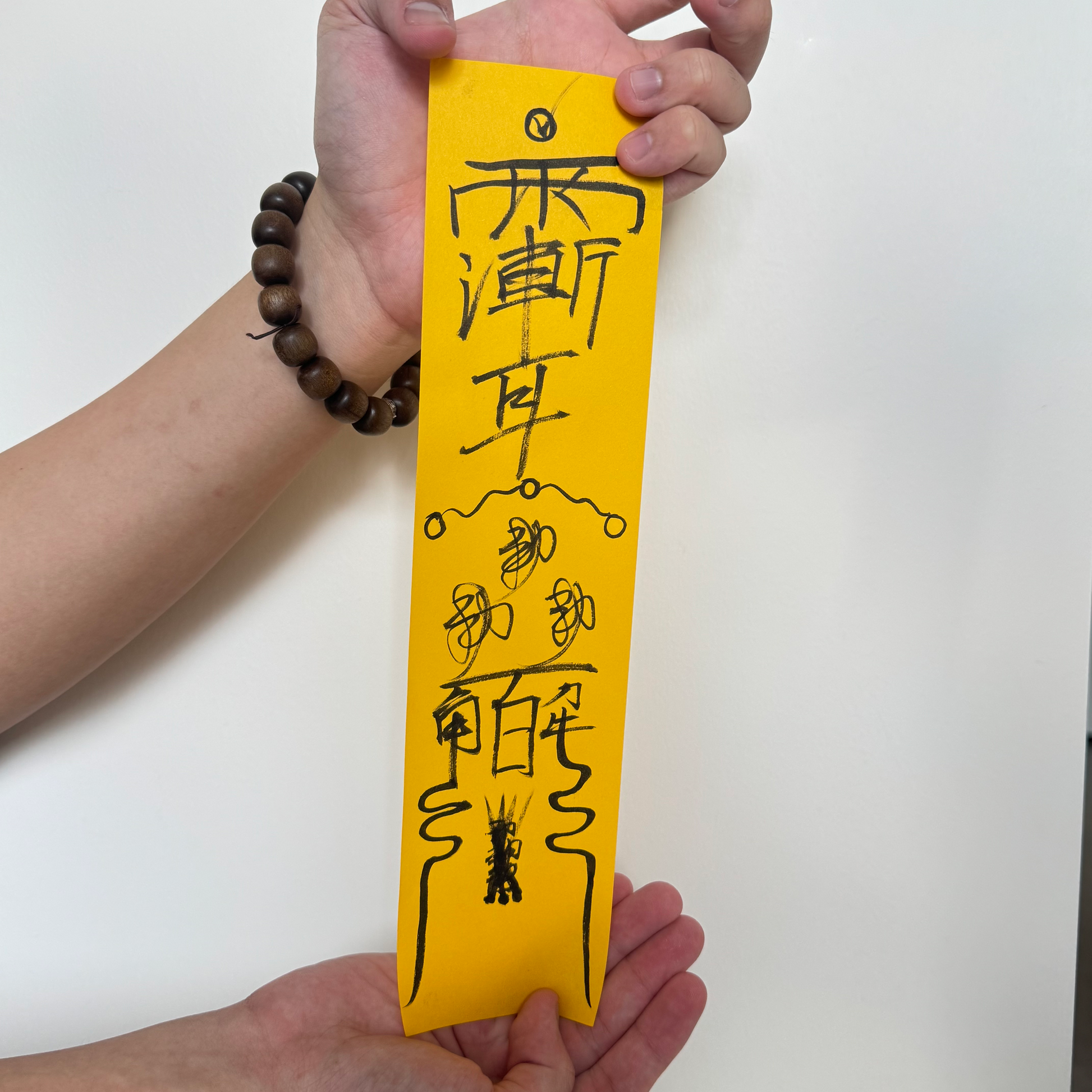 Hand-drawn Taoist talismans on yellow ritual paper