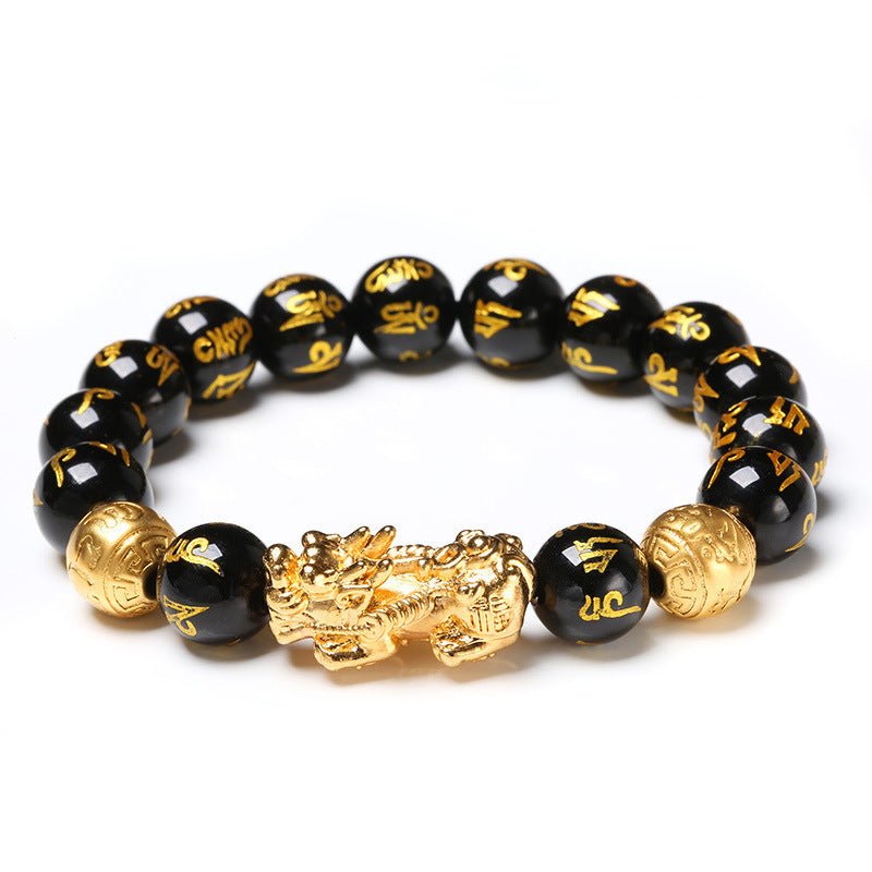 Black obsidian Pixiu bracelet on a white background, with a gold Pixiu charm and the Mani mantra in gold