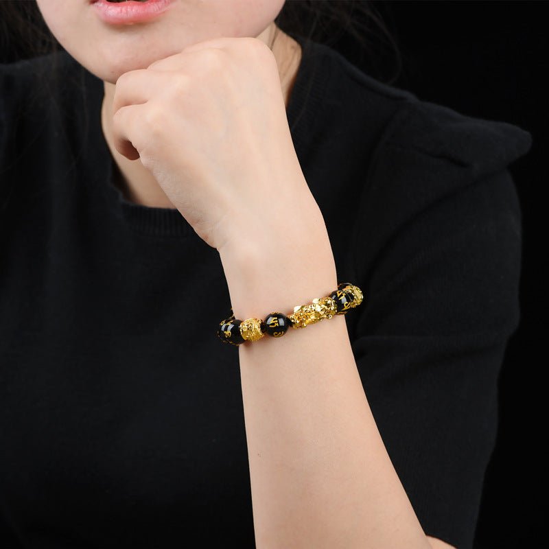 Black obsidian Pixiu bracelet worn on a wrist