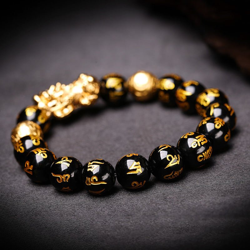 Black obsidian beads with the Mani mantra in gold